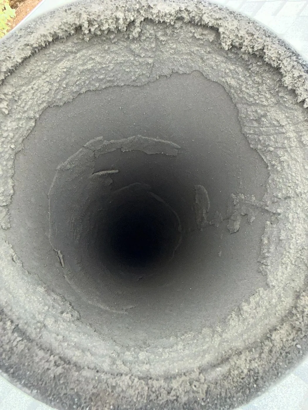 Inside a metal flue — buildup you cannot see from below